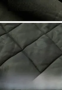 Detailed macro view of gray diamond quilted fabric with thick warm padding and stitching