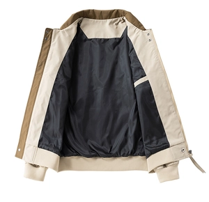 Detail view of khaki bomber jacket showing smooth black lining and internal pocket