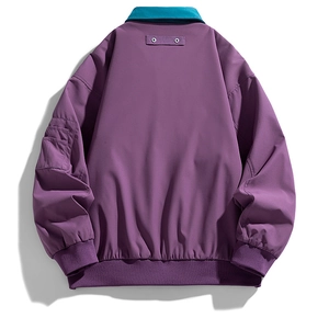 Detail of purple workwear jacket featuring teal contrast collar and ribbed hem