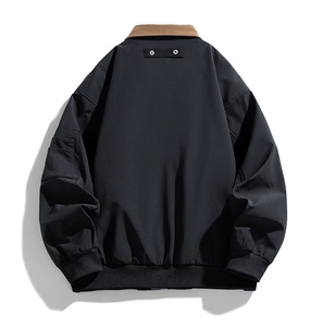 Back view of men's black bomber jacket with brown collar and functional sleeve pocket