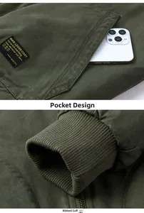 Detail of olive green MA1 jacket featuring spacious utility pockets and ribbed cuffs