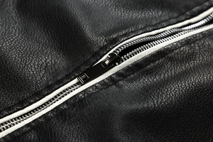 Close-up of black pebbled PU leather texture with high-quality metal zipper details