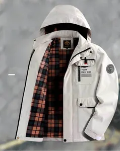 Detail of white parka with red-blue plaid lining and chest pocket embroidery