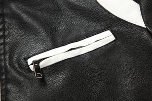 Detail of lychee pattern faux leather jacket with white trim and silver metal zipper