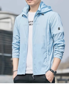 Detail view of light blue sun protection jacket with adjustable hood and arm logo patch