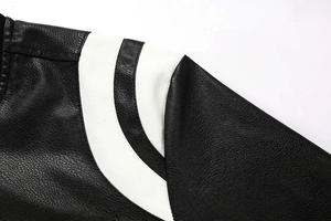 Close-up of the black leather motorcycle jacket with white curved stripe and pebble texture