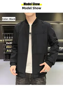 Detail of men's black bomber jacket with ribbed cuffs and embroidered chest logo