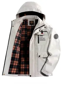 Detail of hooded outdoor jacket featuring classic plaid lining and chest print