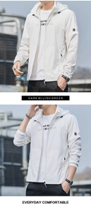 Detail of white hooded sun protection jacket featuring zip closure and sleeve badge decoration