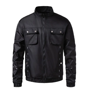 Detail of black motorcycle jacket showing standing collar and metal button pocket