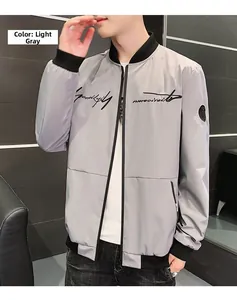 Detail of light gray bomber jacket featuring black ribbed collar and embroidered script logo
