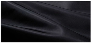 Macro view showing the sleek black satin fabric texture and smooth sheen of the men's jacket