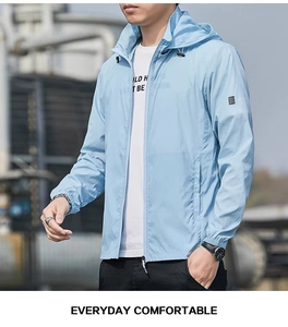 Detail of light blue hooded sun protection jacket with adjustable drawstring and sleeve patch