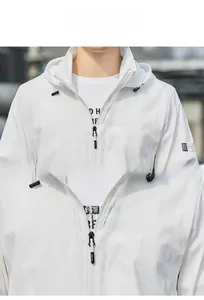 Close-up of white sun protection jacket showing hooded drawstring and metal zipper detail