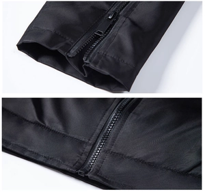 Detail of black technical jacket featuring functional wrist zippers and windproof fabric