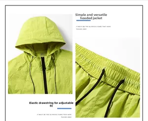 Detail of neon green windbreaker featuring breathable hood and elastic waist drawstrings