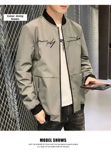 Detail of army green bomber jacket featuring black ribbed cuffs and chest graphic print