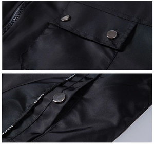 Detail of black motorcycle jacket featuring metal snap button and FASHION printed drawstring