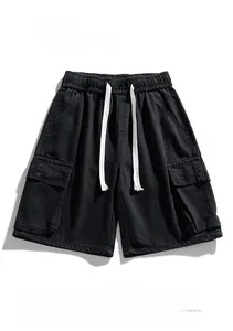 Flat lay of black cargo denim shorts with elastic drawstring waist and large pockets
