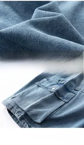 Detail of blue denim fabric texture and large cargo pocket with a metal button