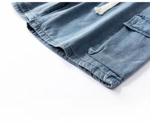 Detail of loose-fit denim cargo shorts showing leg opening design and large flap pocket