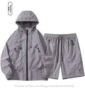 Detail view of light grey hooded windbreaker and shorts set with breathable fabric texture