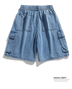 Macro detail of casual blue cargo denim shorts with elastic waist and large side pockets