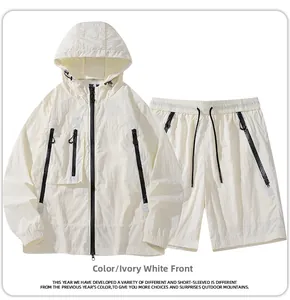 Detail view of ivory white hooded sun-protection jacket and shorts set with black zippers