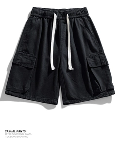 Detail view of cargo shorts featuring elastic waist, white drawstring and large side pockets