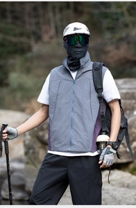 Detail view of a color-block outdoor vest for hiking with windproof zipper and high collar