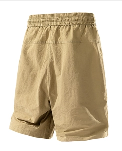 Detailed view of water-resistant fabric texture and elastic waistband on khaki shorts