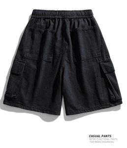 Rear view of black cargo shorts with elastic drawstring waist and large utility pockets