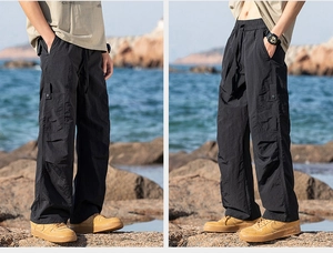 Close-up of black cargo pants with large side pockets and durable technical fabric