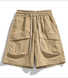 Detail view of khaki water-repellent cargo shorts with elastic waist and metal D-ring hook