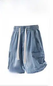 Detail of light blue denim cargo shorts featuring an elastic drawstring waist and side pockets