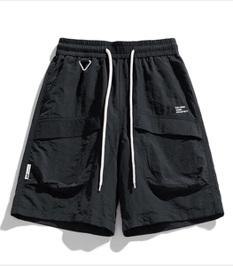 Detail of water-resistant cargo shorts with elastic drawstring waist and large 3D pockets