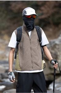Detail of outdoor hiking vest with multi-pockets and contrast color paneling