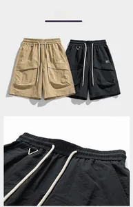 Detail of cargo shorts showing elastic waistband, drawstring, and quick-dry fabric texture