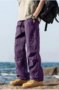 Macro shot of deep purple cargo pants with drawstring waist and textured quick-dry fabric