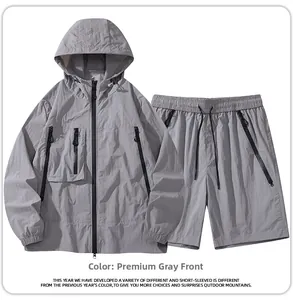 Front view of grey outdoor hooded jacket and shorts set with black zipper details