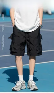 Detail of black cargo shorts featuring functional pockets in a casual outdoor setting