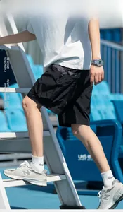 Detail of black summer cargo shorts with quick-dry fabric and drawstring utility pocket