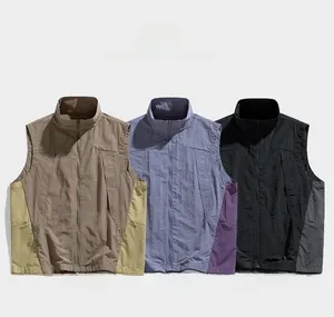 Detailed macro view of three outdoor utility vests in khaki, blue, and black colors