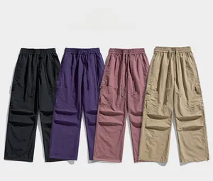 Detail showing elastic drawstring waist and cargo pockets on casual wide-leg trousers