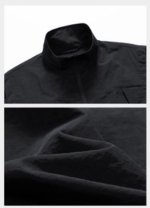 Detail of outdoor vest with stand collar, zipper structure and crinkled nylon fabric texture