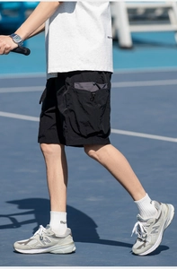 Detail of black utility cargo shorts with grey contrast pockets and adjustable drawstrings