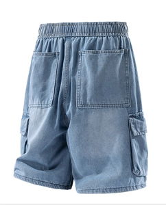 Detail of light blue washed denim shorts featuring large utility cargo pockets and elastic waist