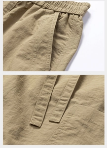Detail of khaki quick-dry cargo shorts featuring elastic waistband and reinforced stitching