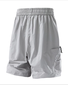 Detail of light grey cargo shorts featuring elastic waist and large side flap pocket