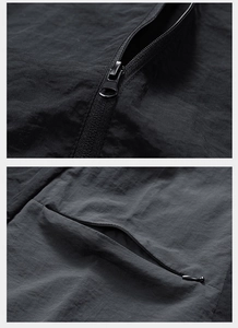 Detail of durable black windproof fabric and metal zippers on a versatile outdoor vest